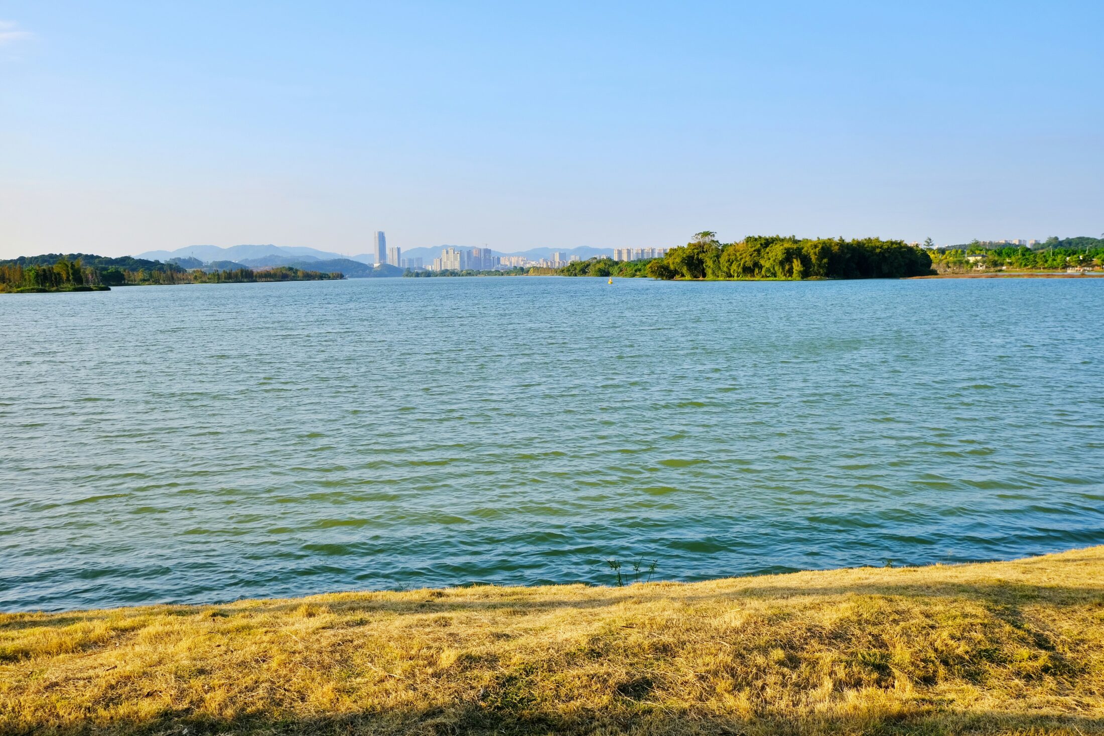 a large body of water with a city in the background