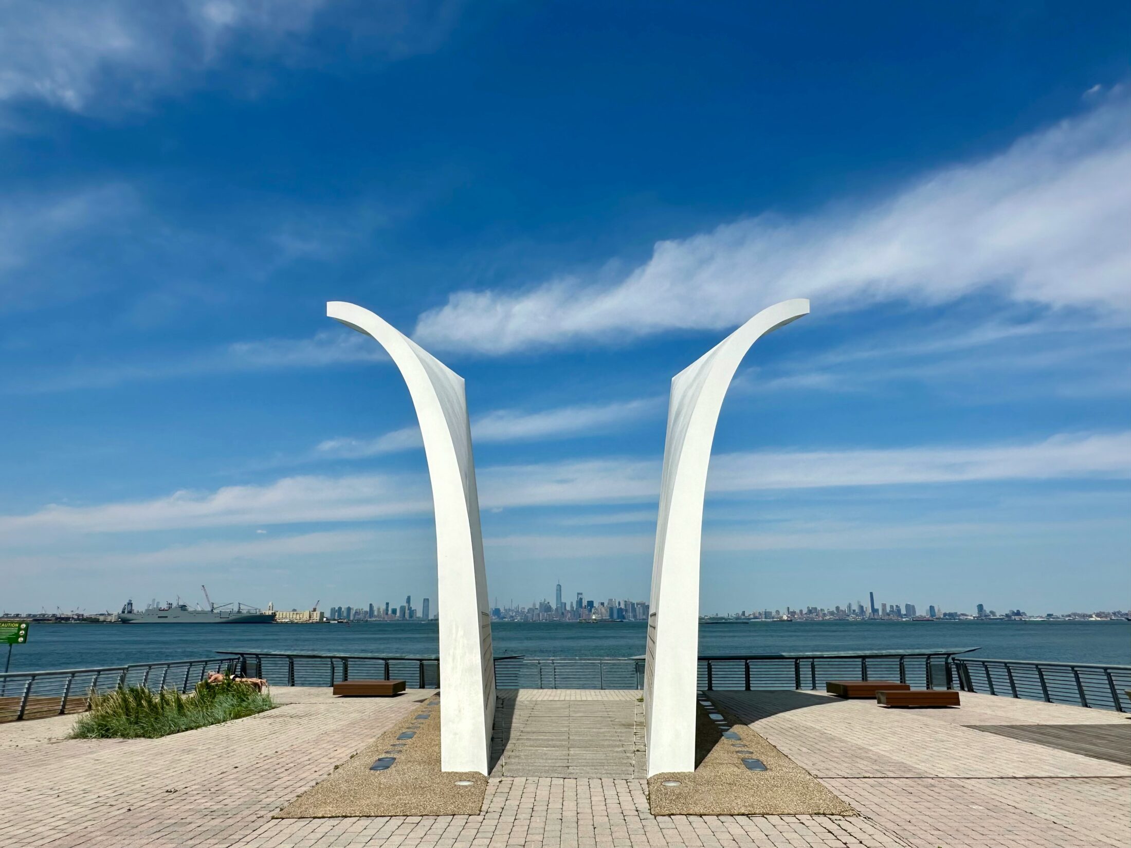 a lar white arch sitting next to a body of water