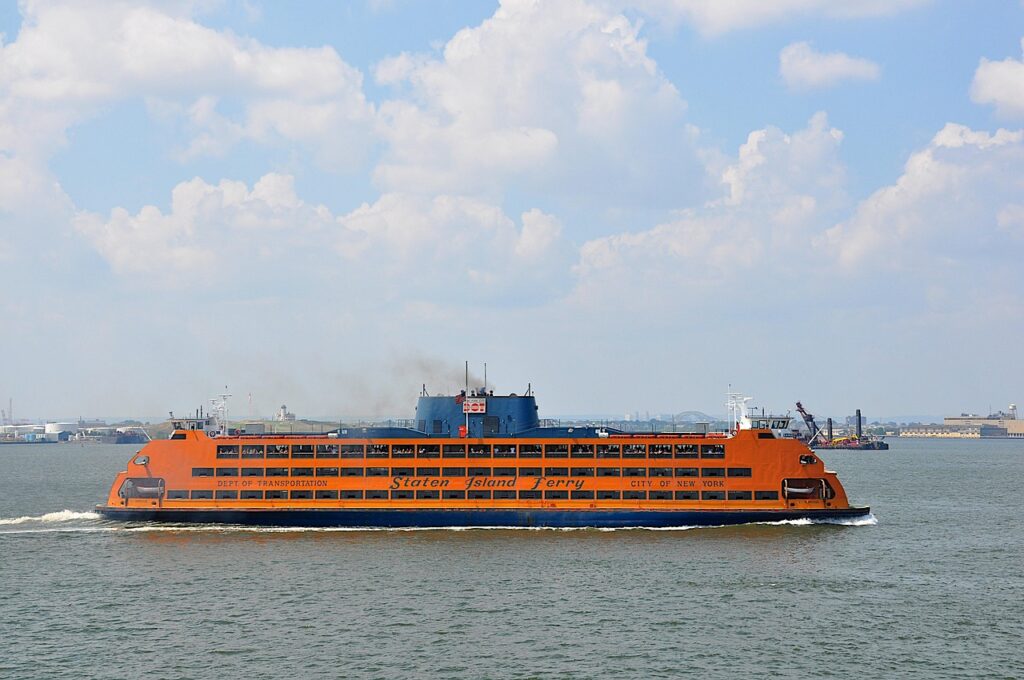 a huge orange ship in the middle of a body of water
