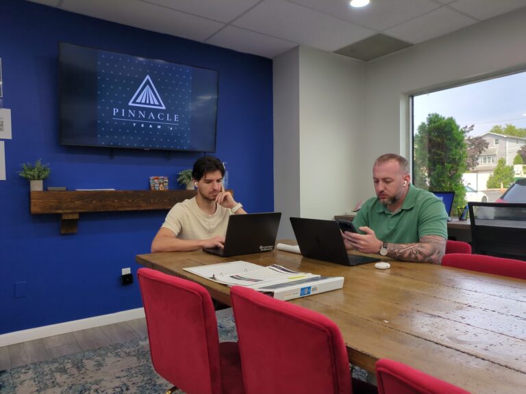 Simon Umanoff and Frank Bergen working at the conference table in the Pinnacle Team office on Willowbrook Road