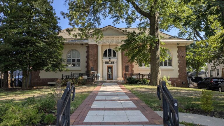 Brick building with a columned entrance and arched windows in Tottenville