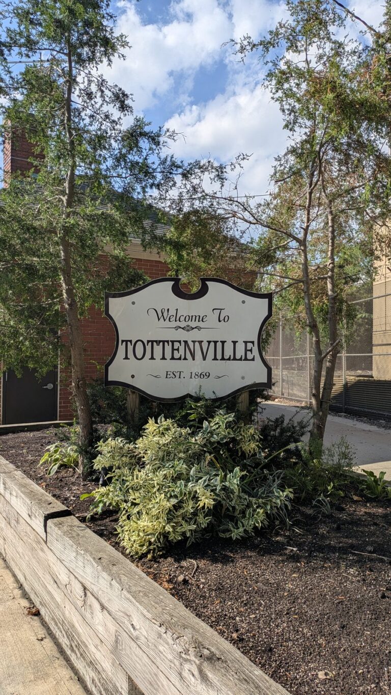 Carved Welcome To Tottenville sign reading established 1869